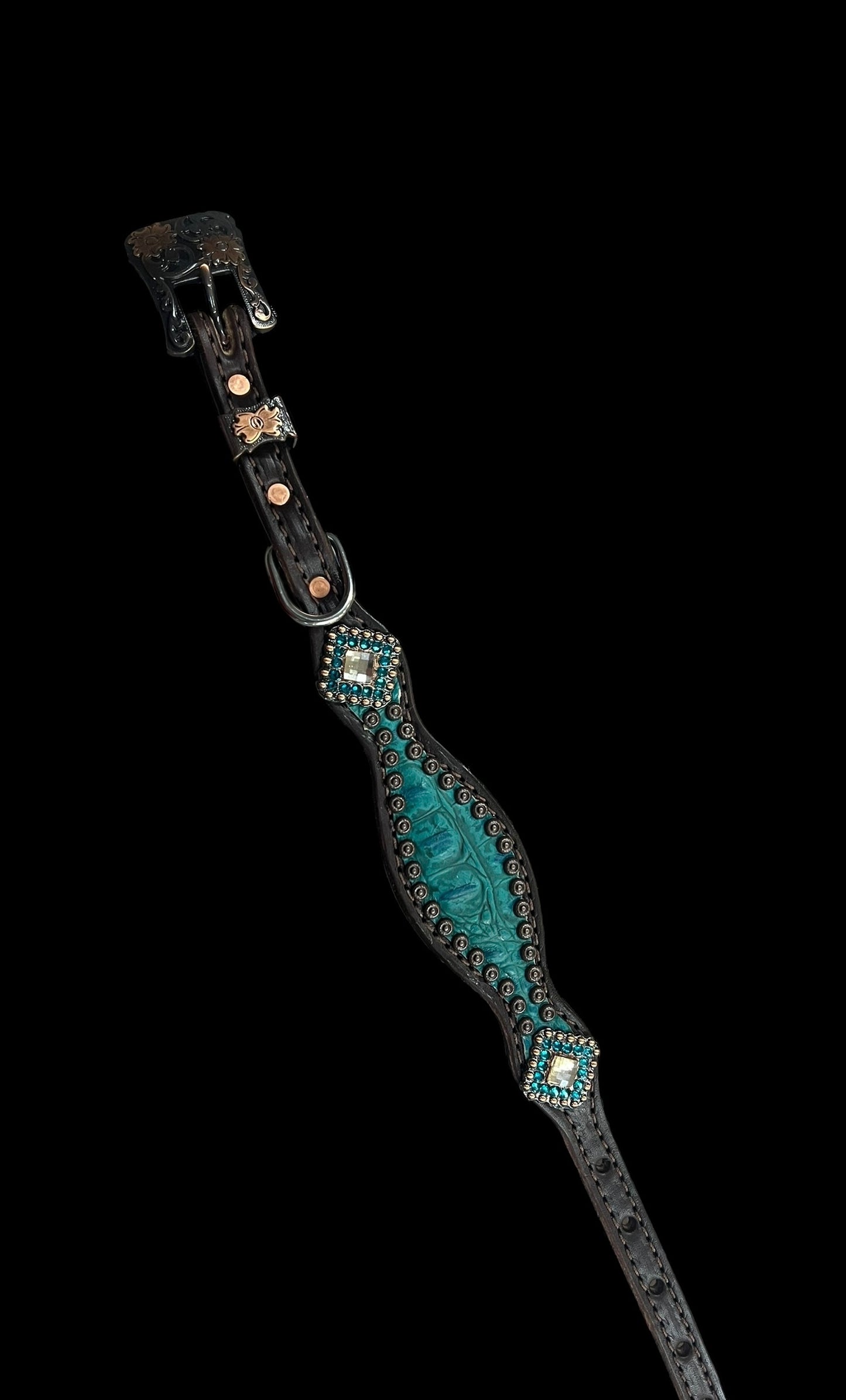 Teal gator on dark leather