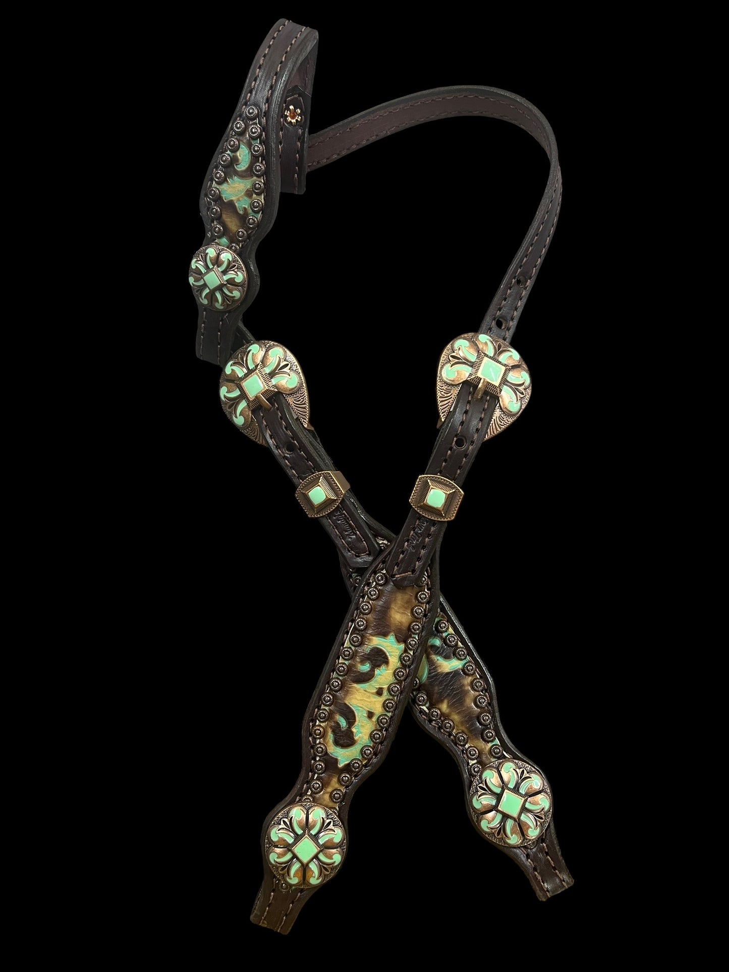 Brown and turquoise corona on dark leather