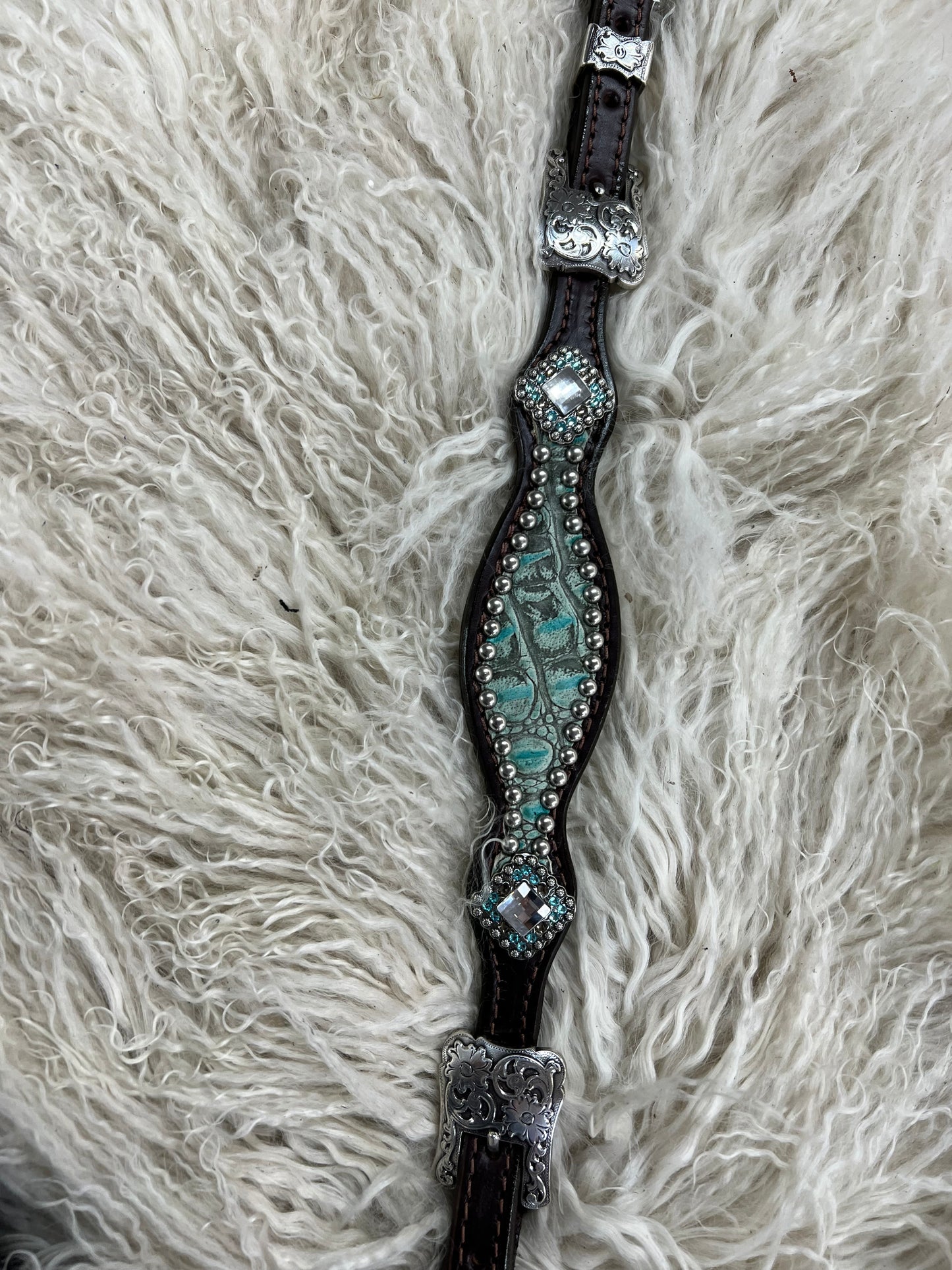 Antique turquoise gator on dark leather