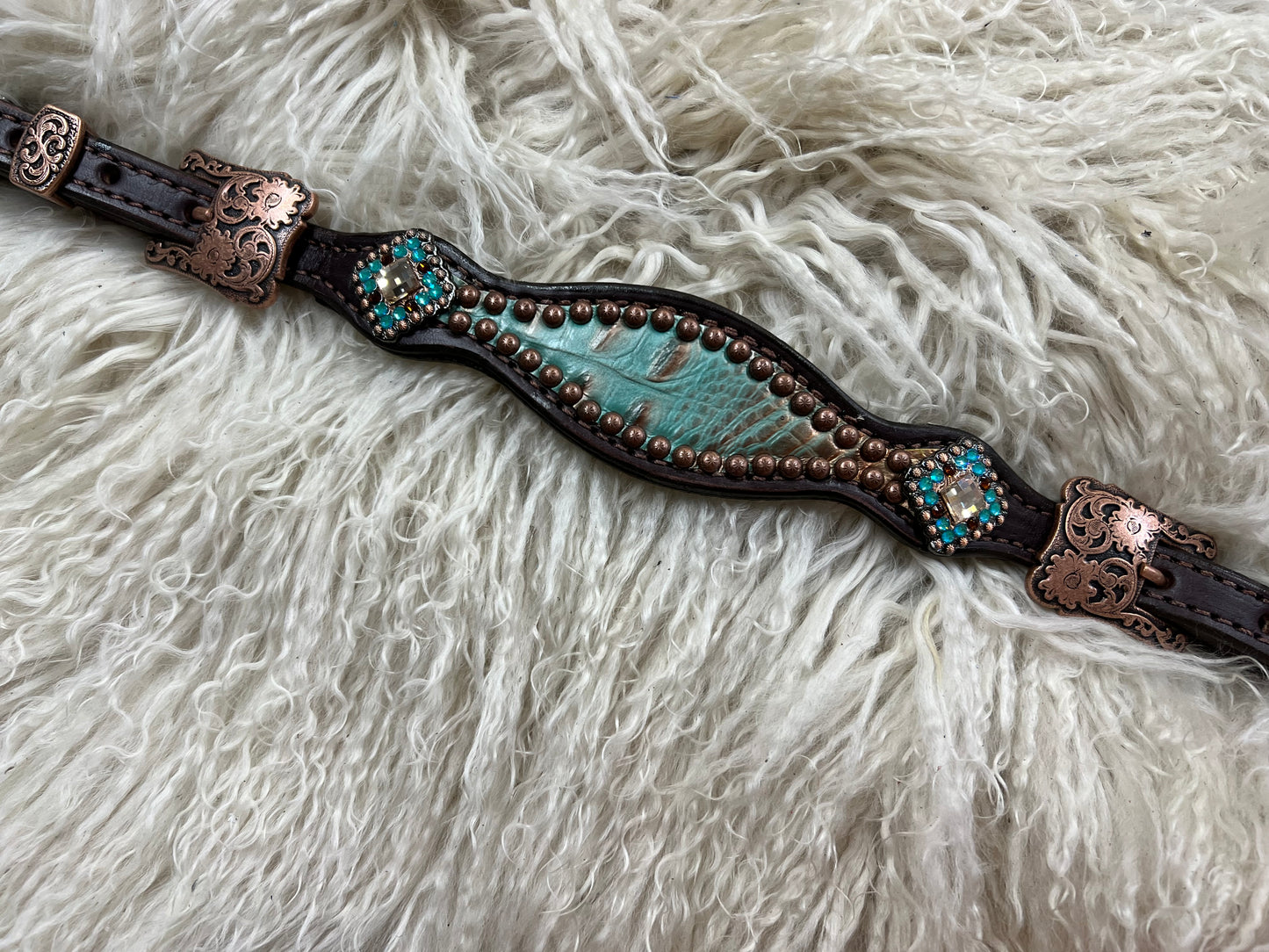 Brown and teal gator on dark leather