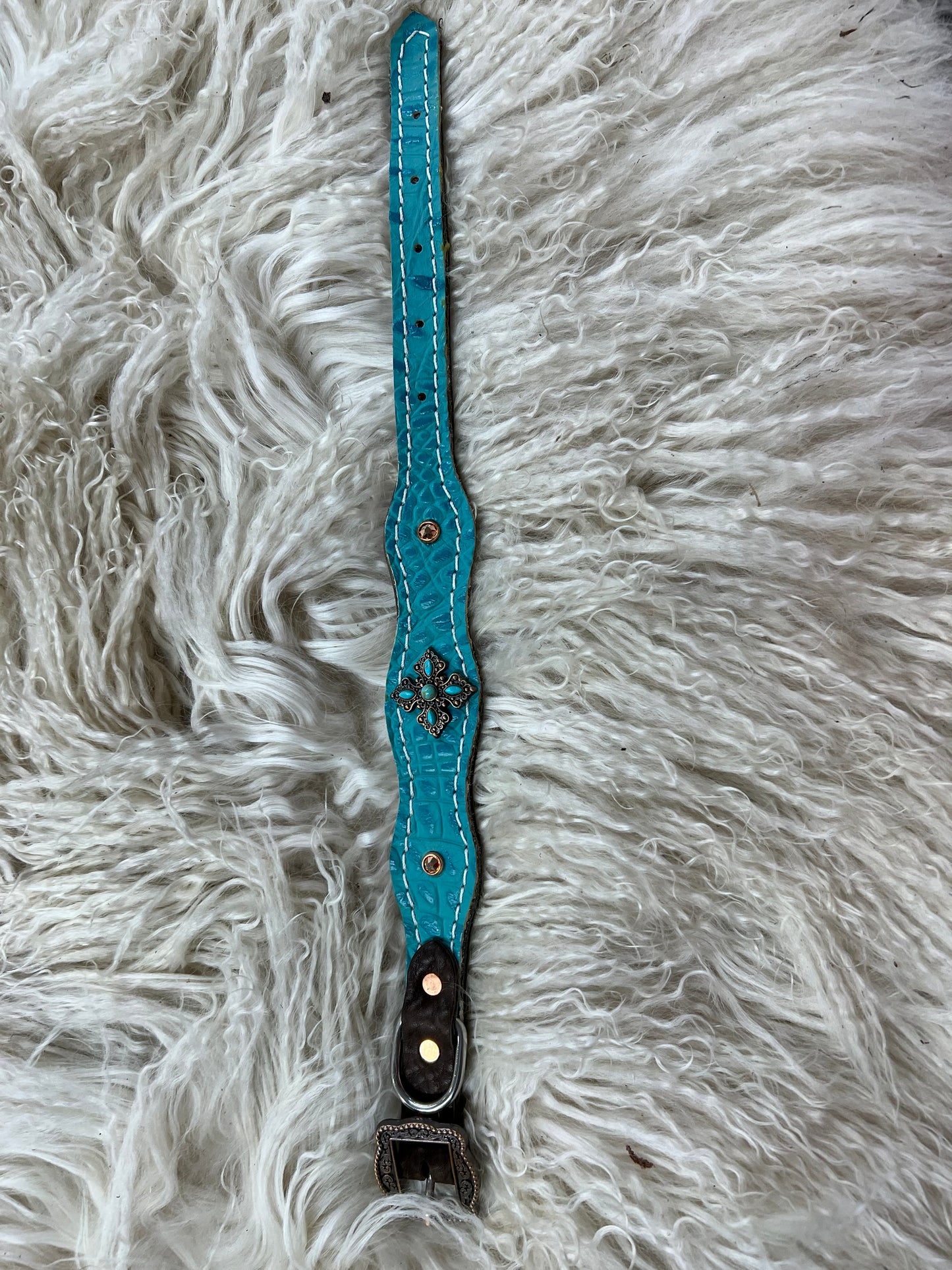 Turquoise gator on dark leather