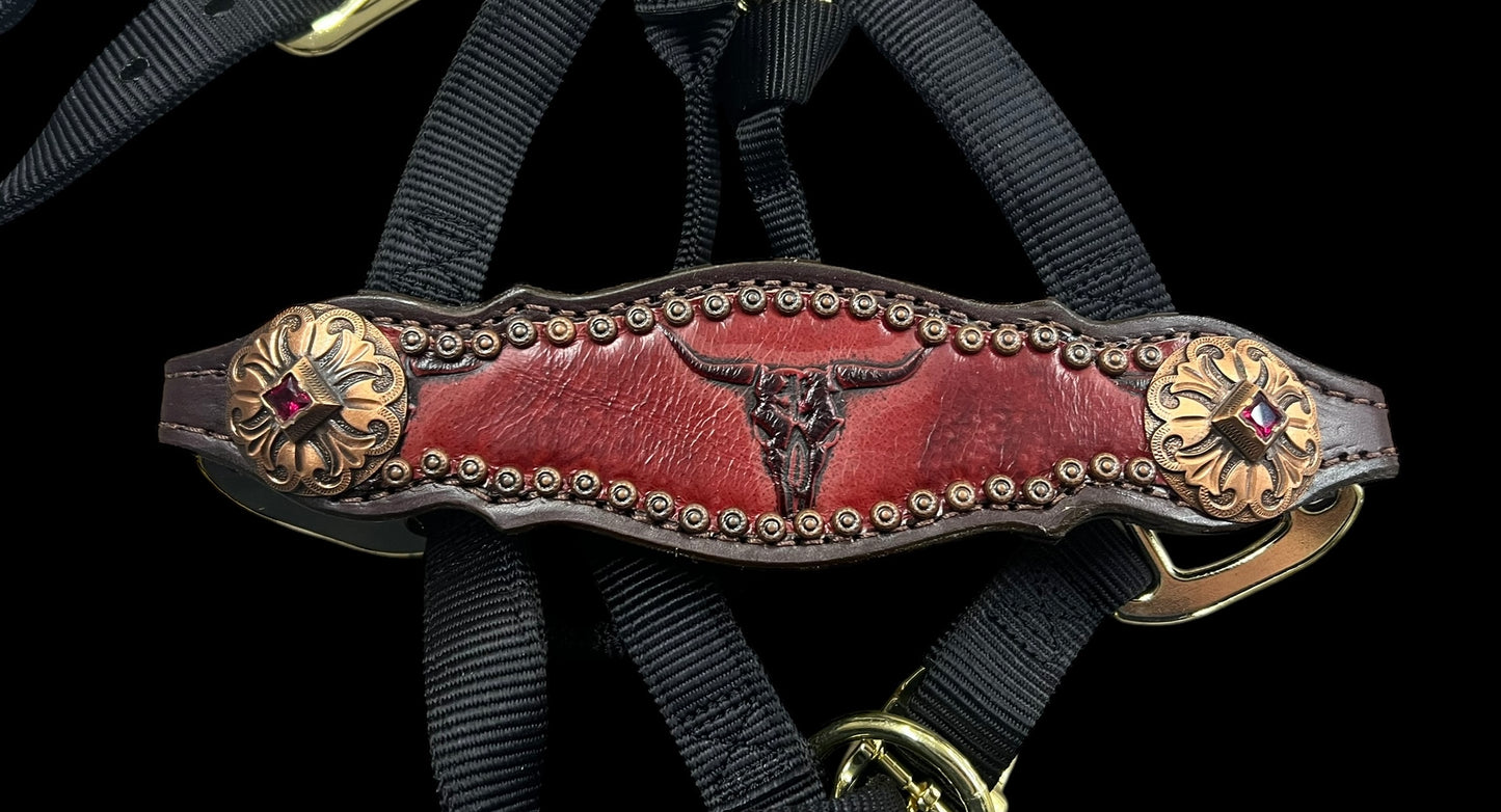 Red longhorns on dark leather