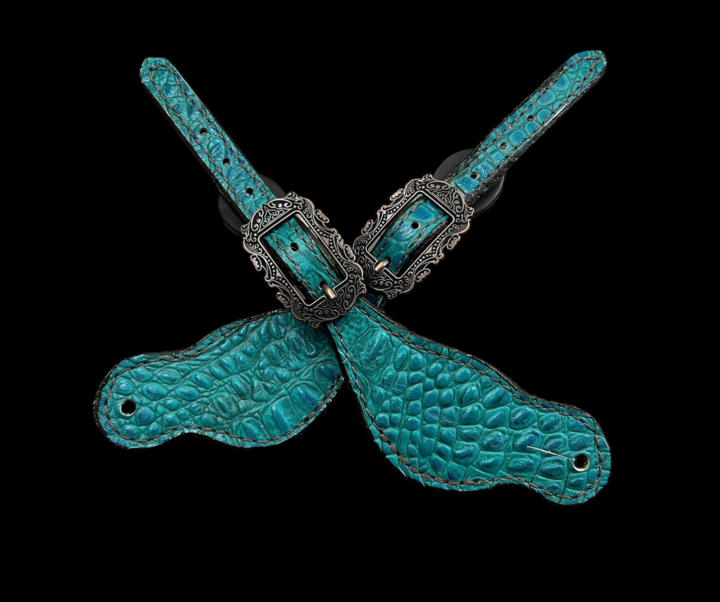 Teal gator on dark leather