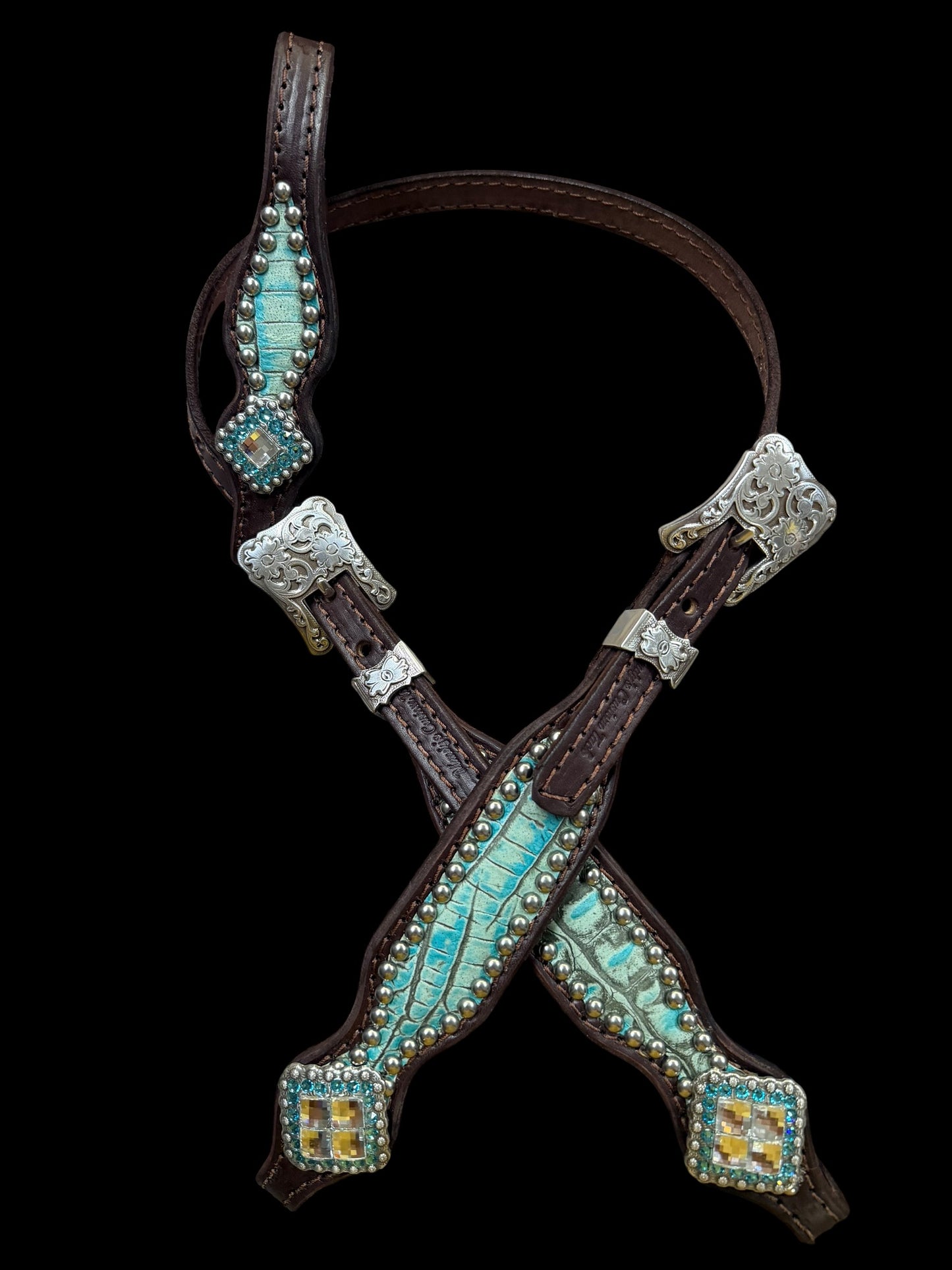 Antique turquoise gator on dark leather