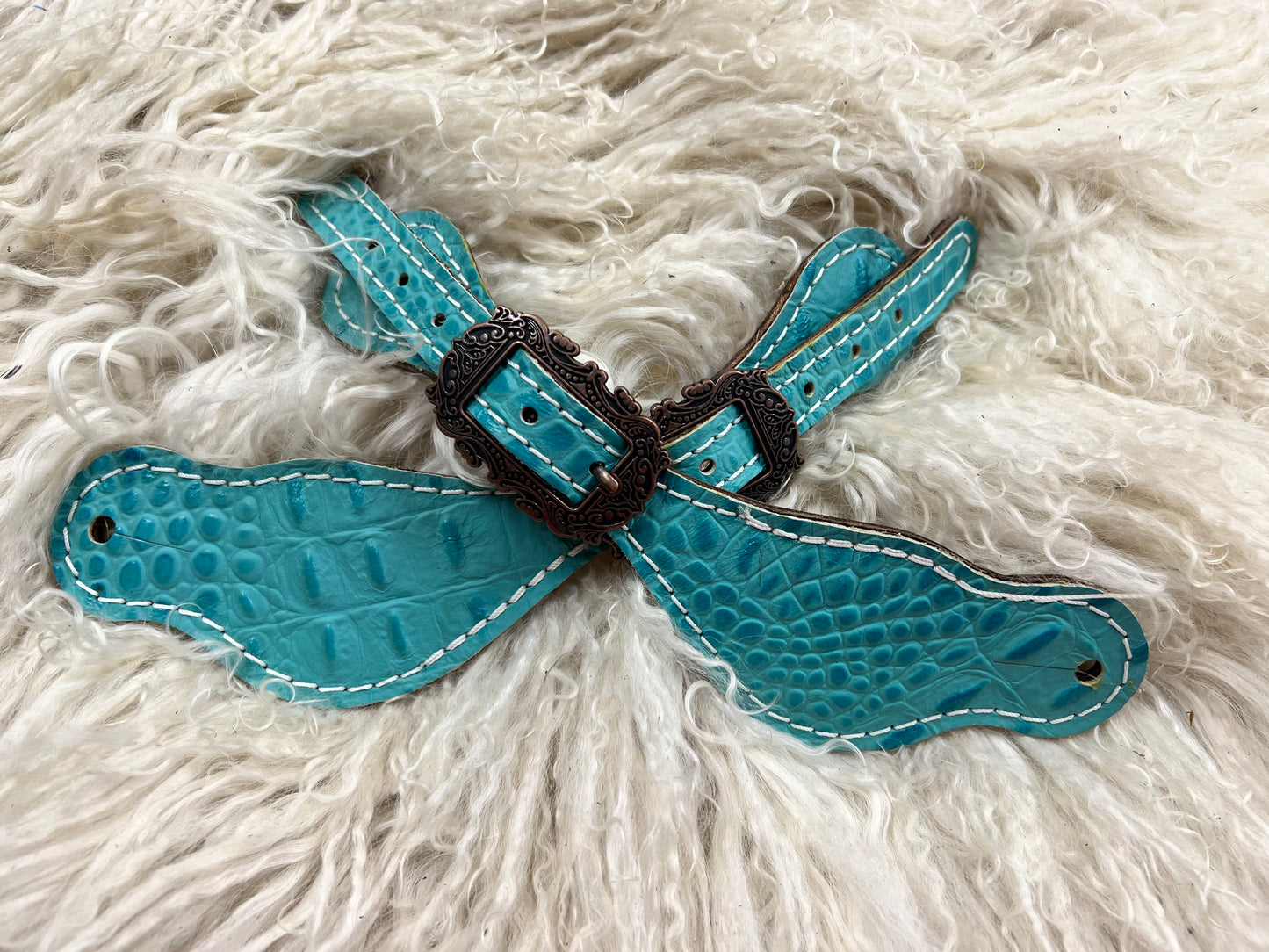 Turquoise gator on dark leather