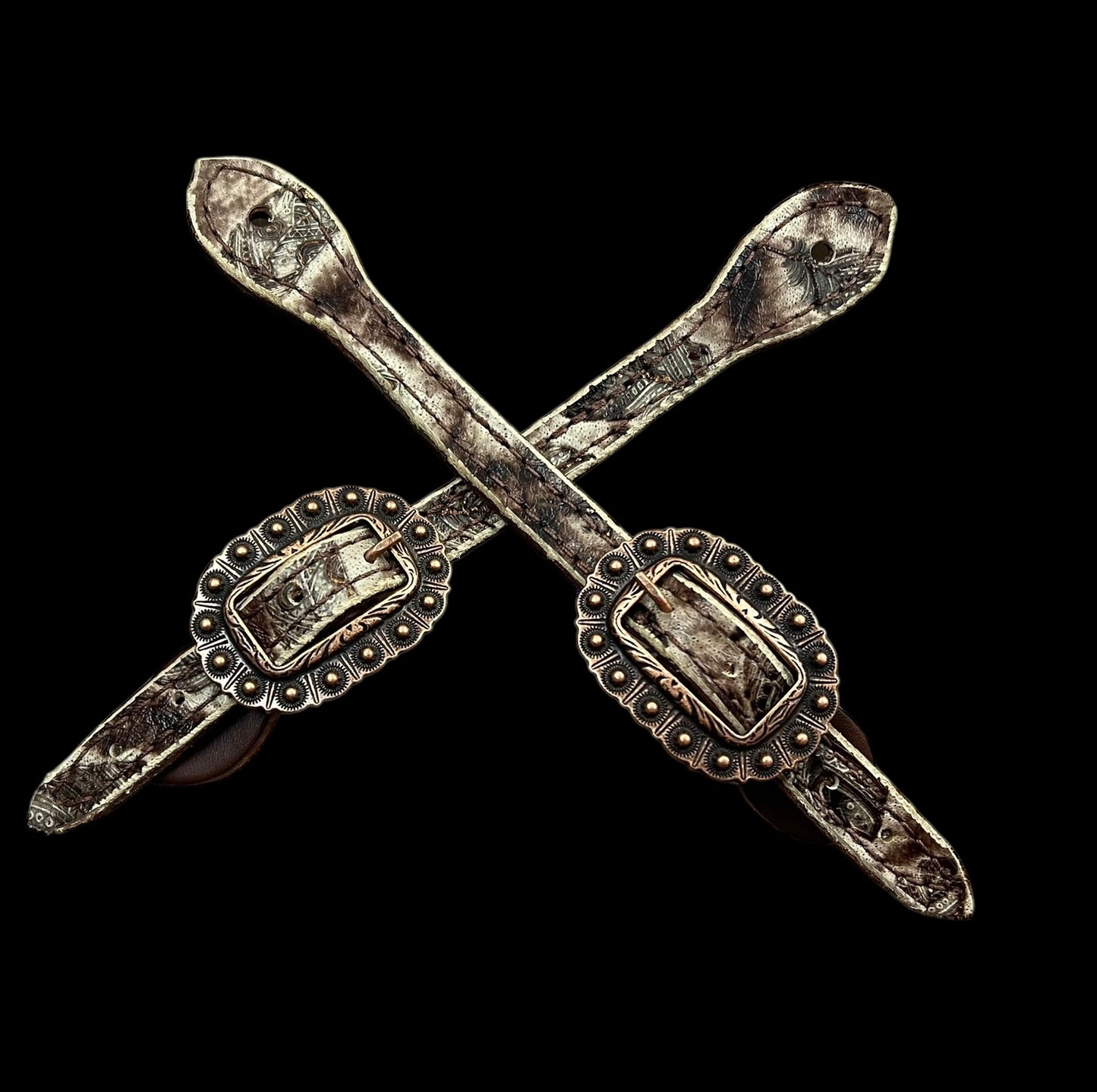 Cream and brown feathers on dark leather