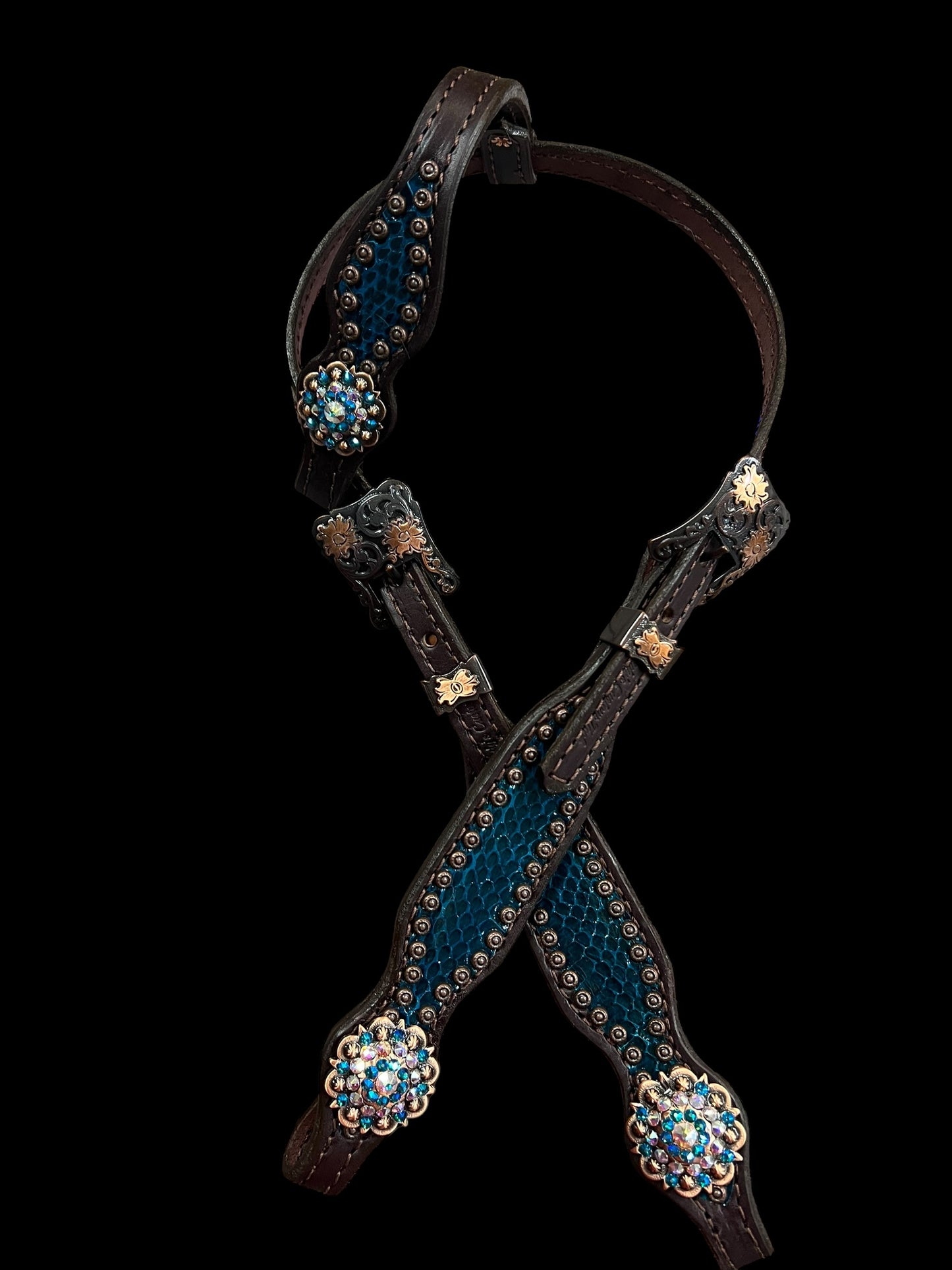 Teal snake on dark leather