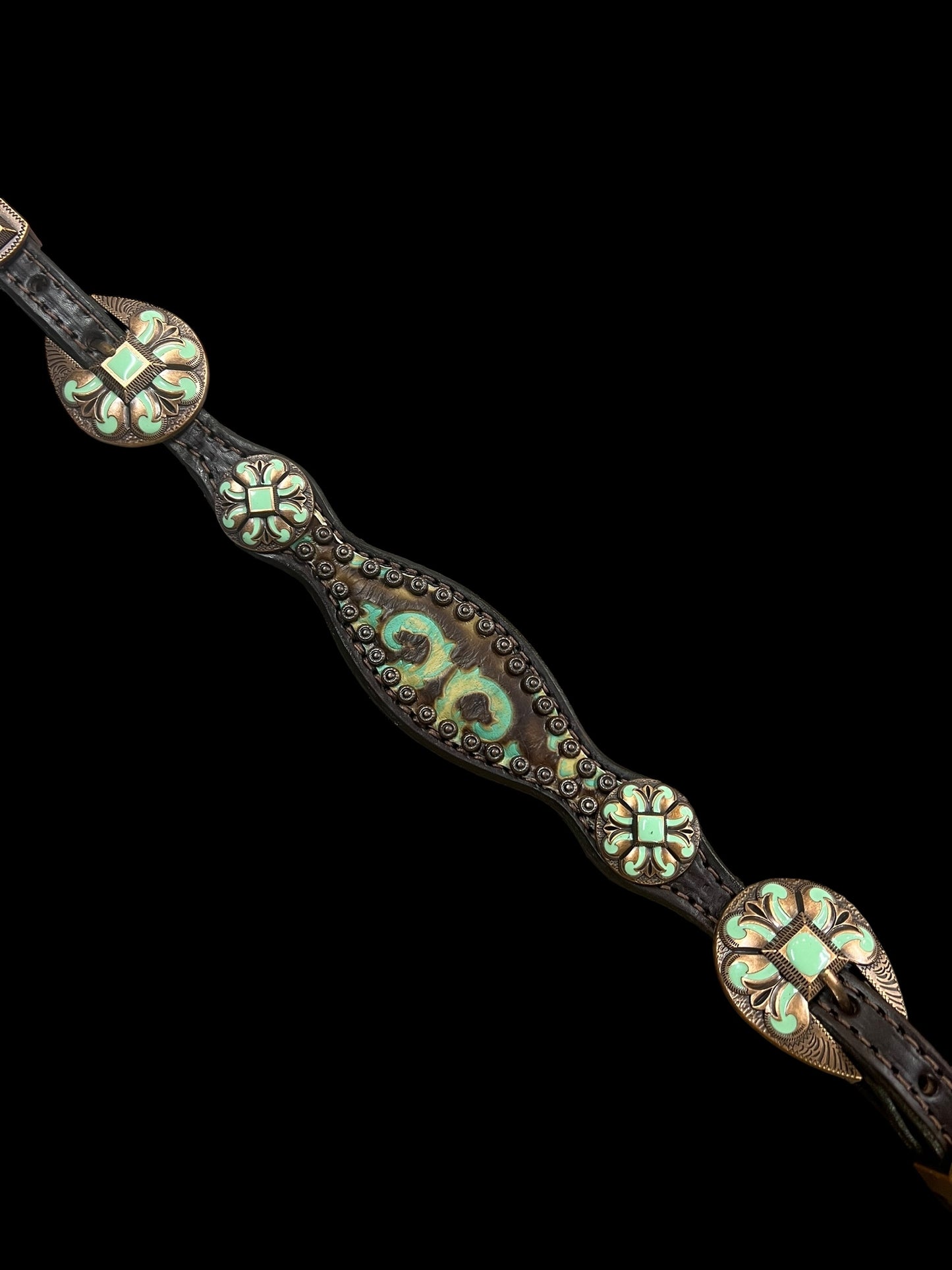 Brown and turquoise corona on dark leather