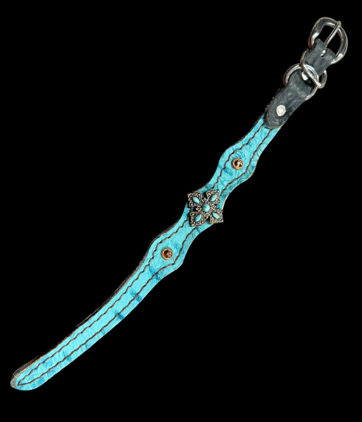Turquoise gator on dark leather
