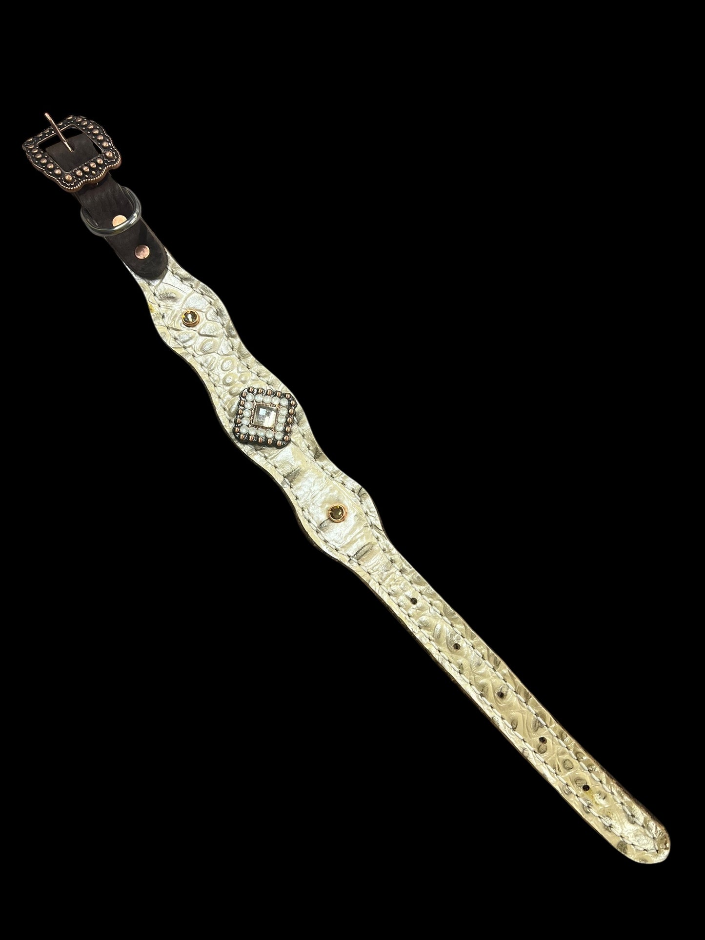 Champagne gator on dark leather