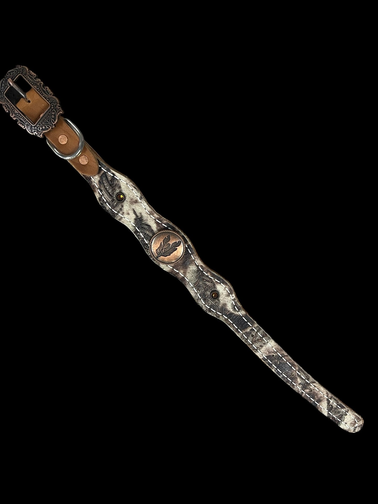 Cream and brown feathers on dark leather