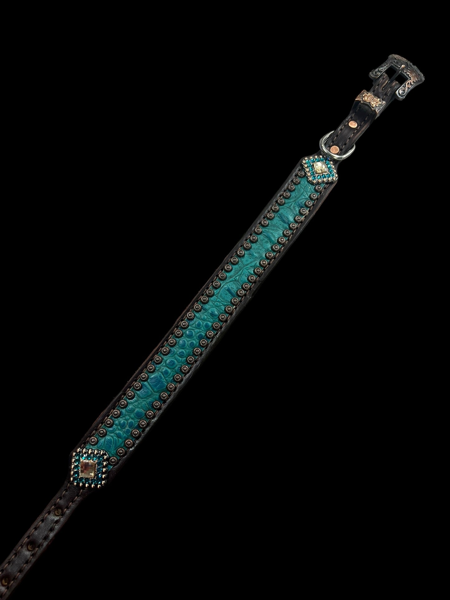 Teal gator on dark leather