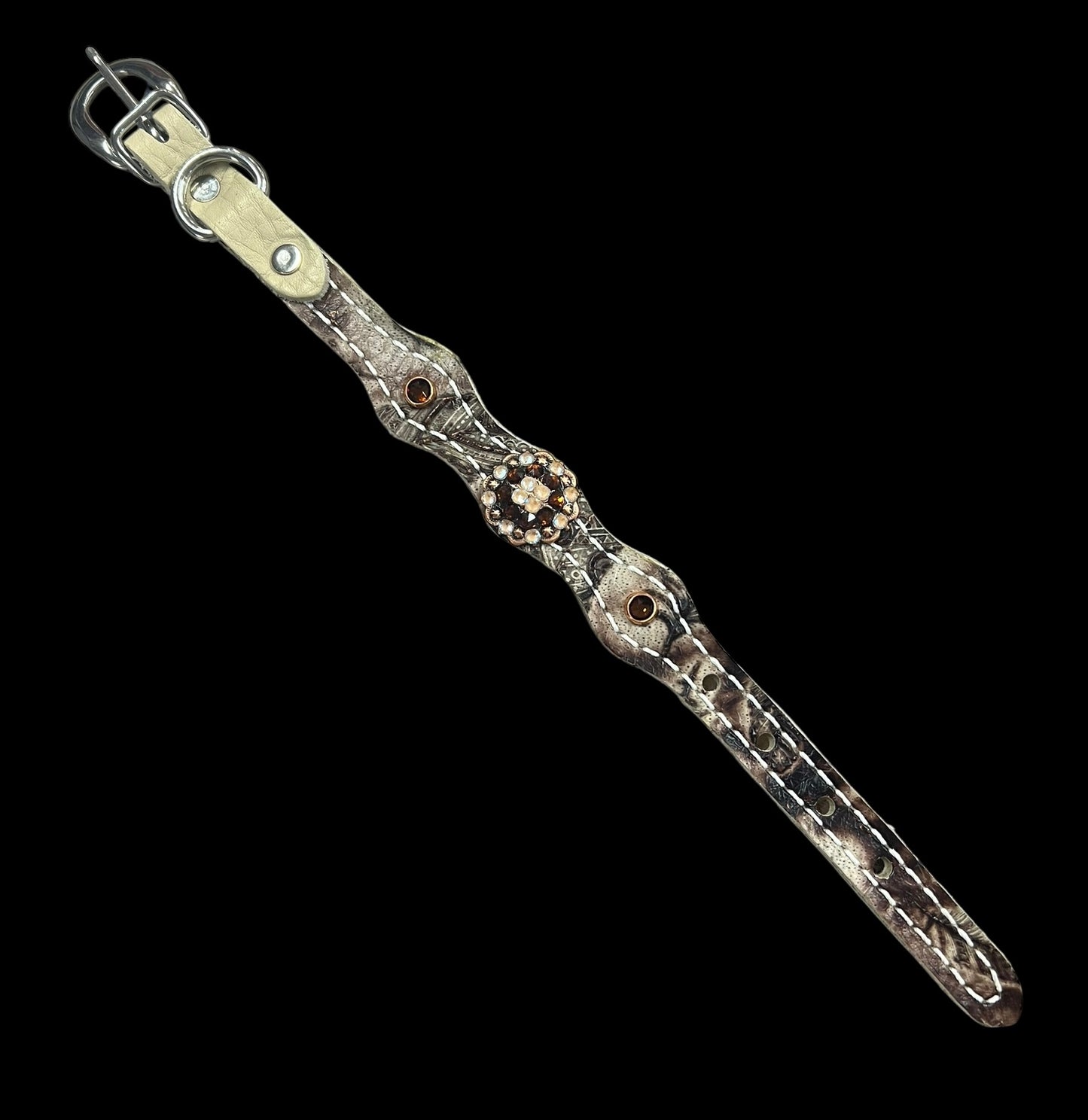 Cream and brown feathers on dark leather