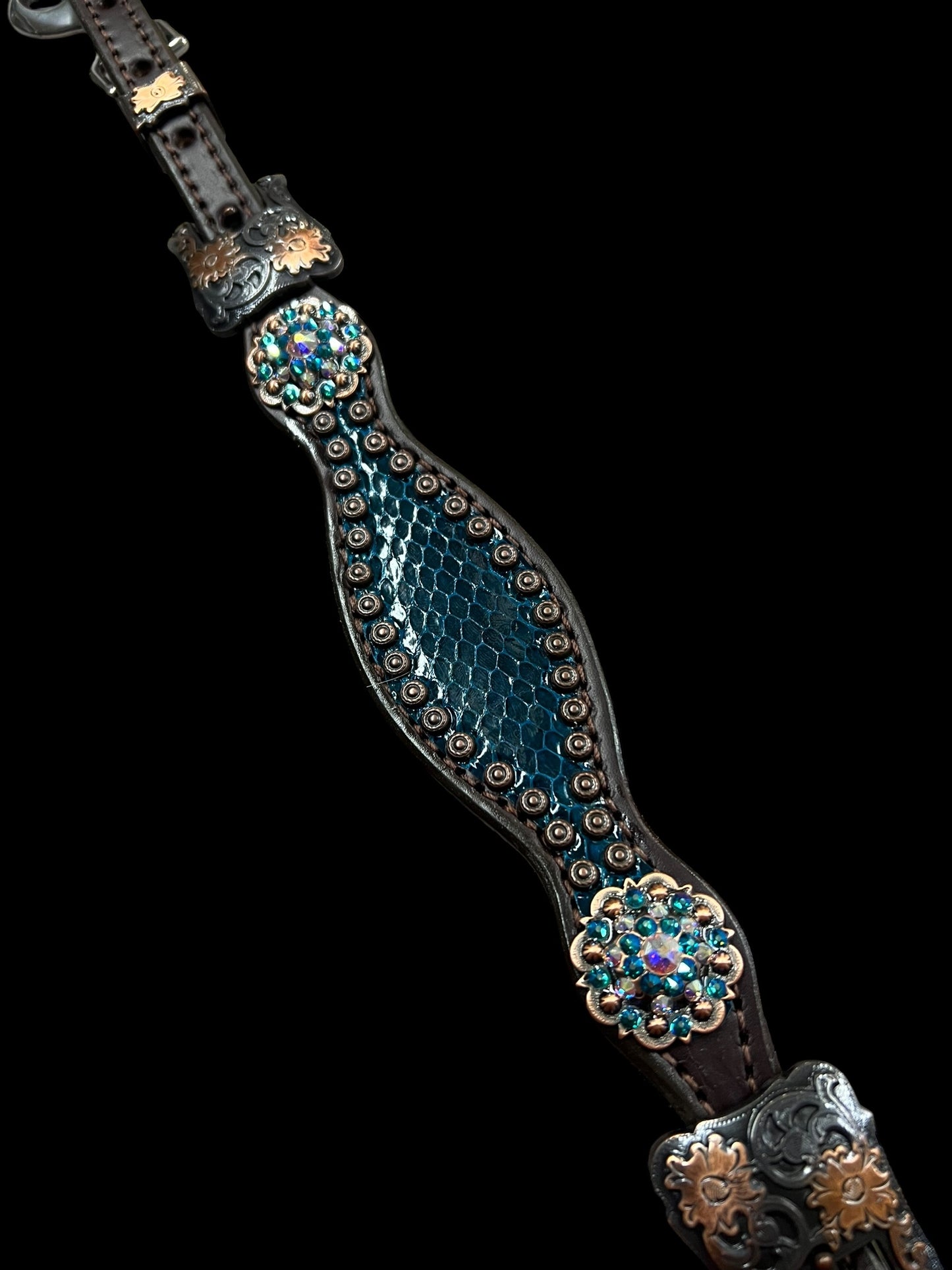 Teal snake on dark leather