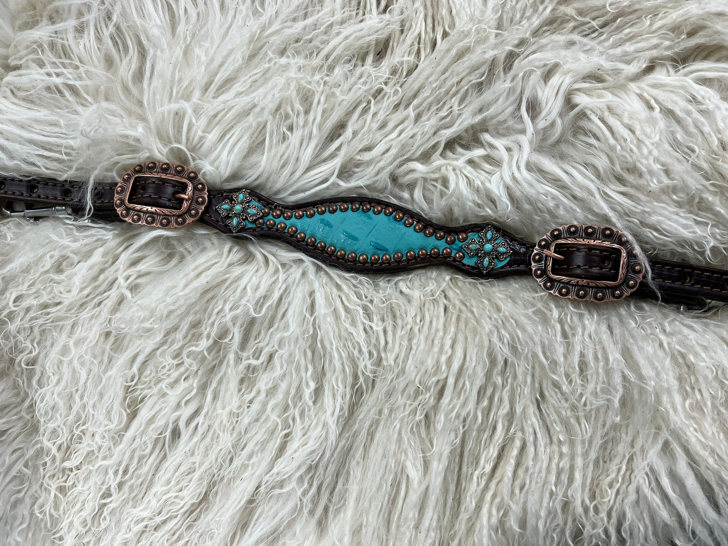 Turquoise gator on dark leather